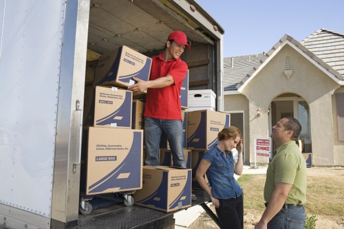Professional moving team loading furniture for a London property move